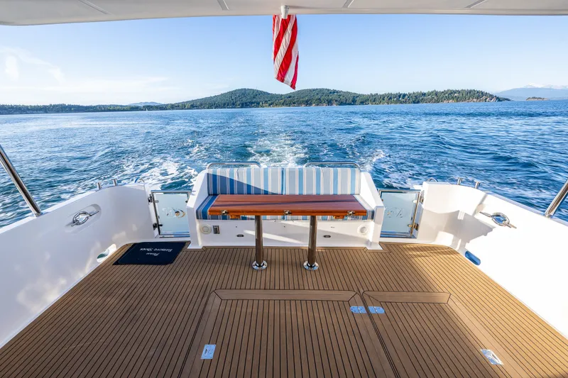 Slide: The Image of Luxury deck of 2023 North Pacific 53 Euro yacht cruising on serene waters. - 69