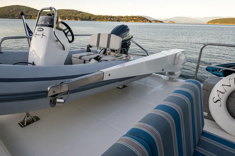 Slide: The Image of 2023 North Pacific 53 Euro yacht deck with dinghy and scenic water view. - 60