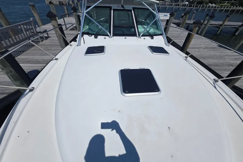 Slide: The Image of 2005 Tiara Yachts 3600 Open boat deck at dock, featuring hatches and railings. - 22