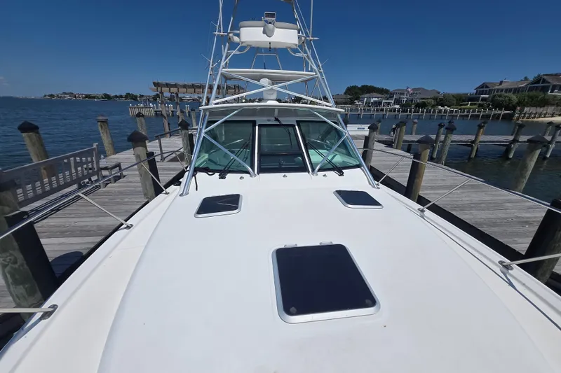 Slide: The Image of 2005 Tiara Yachts 3600 Open docked at a marina, clear blue sky. - 23