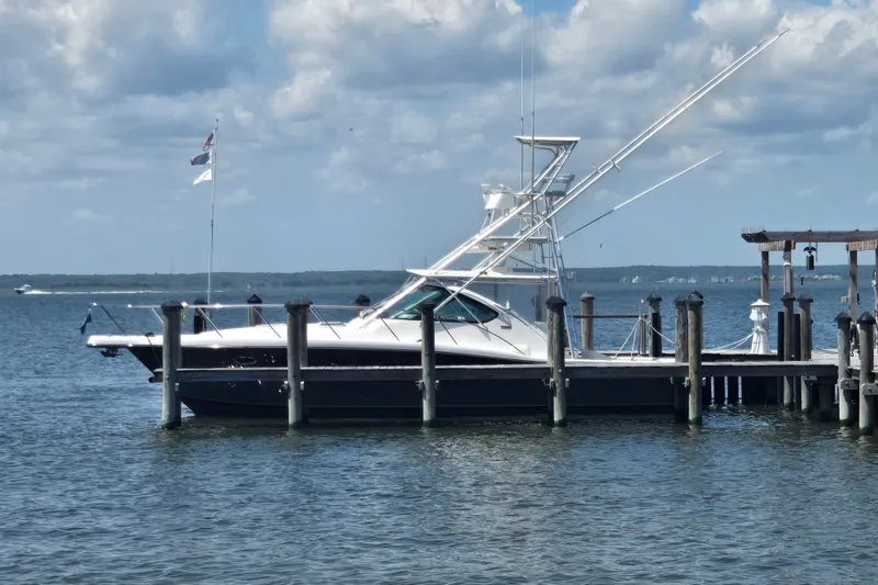 The Image of 2005 Tiara Yachts 3600 Open docked by the waterfront under a cloudy sky. - 0