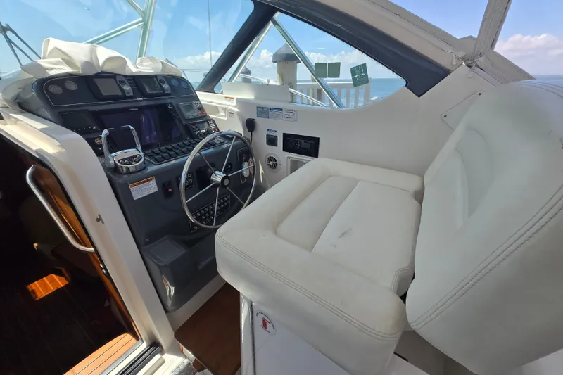 Slide: The Image of 2005 Tiara Yachts 3600 Open helm with steering wheel and navigation controls. - 13