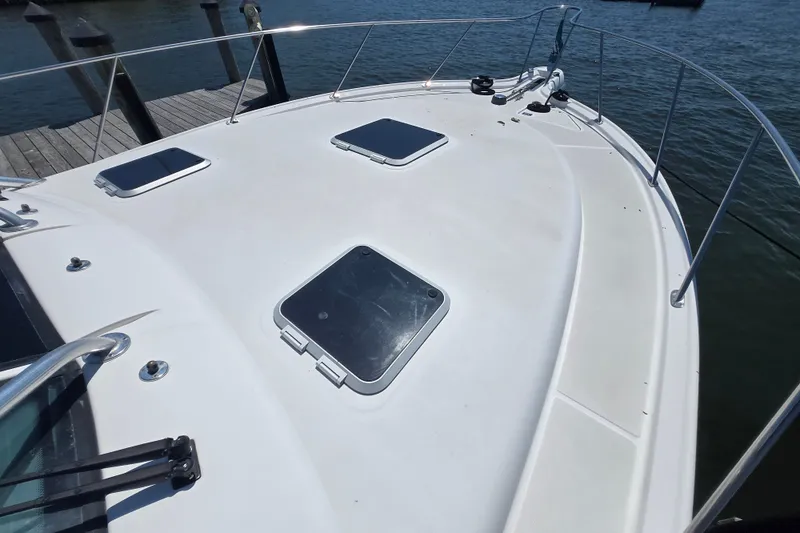 Slide: The Image of 2005 Tiara Yachts 3600 Open boat deck with hatches, docked by the water. - 20