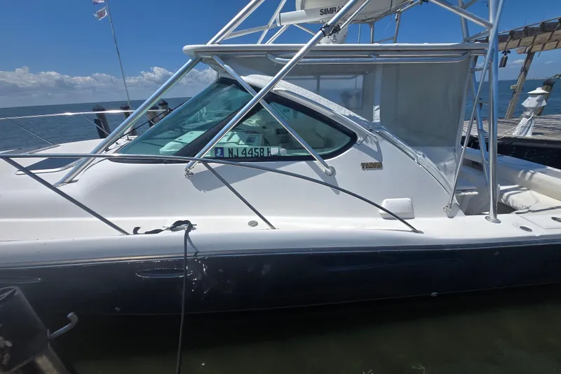 Slide: The Image of 2005 Tiara Yachts 3600 Open docked, showcasing sleek design and sturdy build. - 25