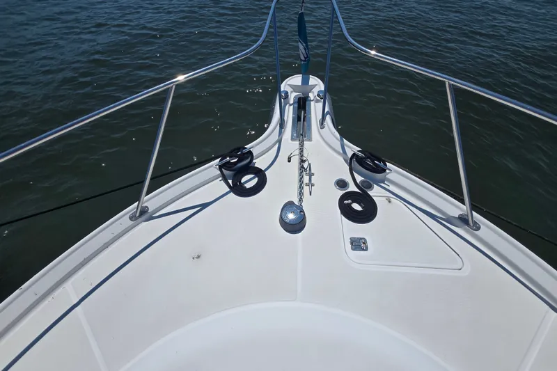 Slide: The Image of Bow view of 2005 Tiara Yachts 3600 Open on water, showcasing deck and railing. - 21
