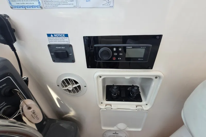 Slide: The Image of Control panel of a 2005 Tiara Yachts 3600 Open, featuring audio system and switches. - 15