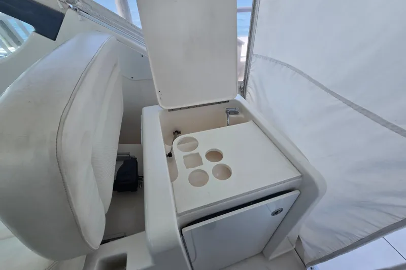Slide: The Image of 2005 Tiara Yachts 3600 Open interior with cup holders and storage compartment. - 16