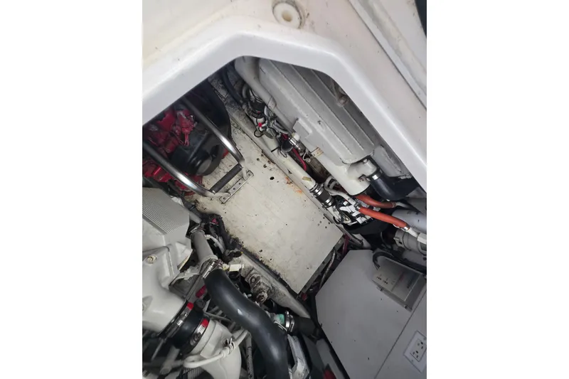 Slide: The Image of Engine compartment of a 2005 Tiara Yachts 3600 Open, showcasing mechanical components and wiring. - 27