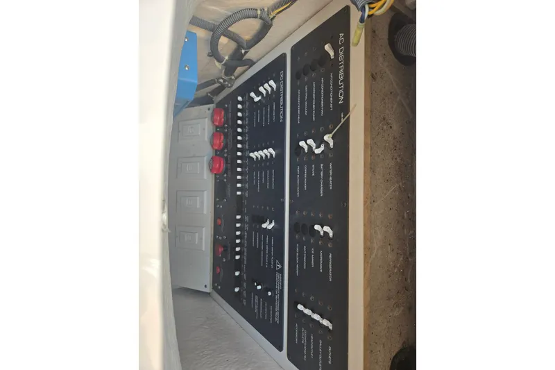 Slide: The Image of Electrical panel of a 2005 Tiara Yachts 3600 Open, featuring AC distribution controls. - 29
