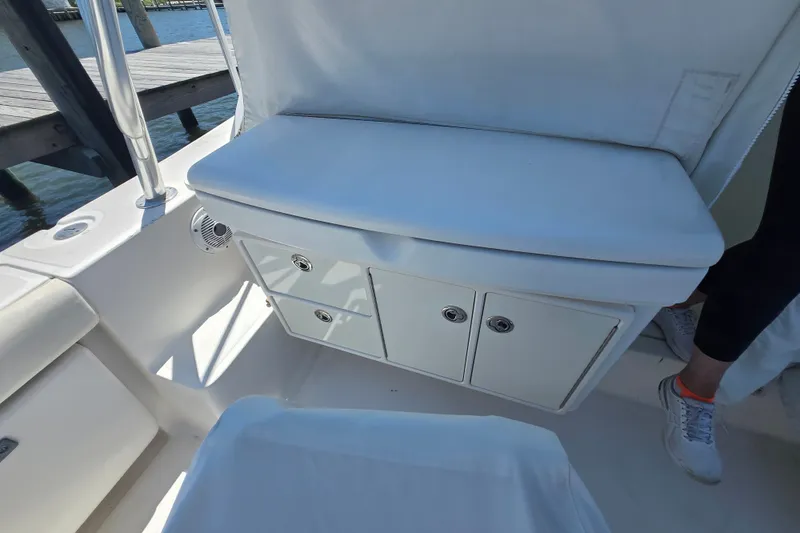 Slide: The Image of 2005 Tiara Yachts 3600 Open interior with white seating and storage compartments. - 17