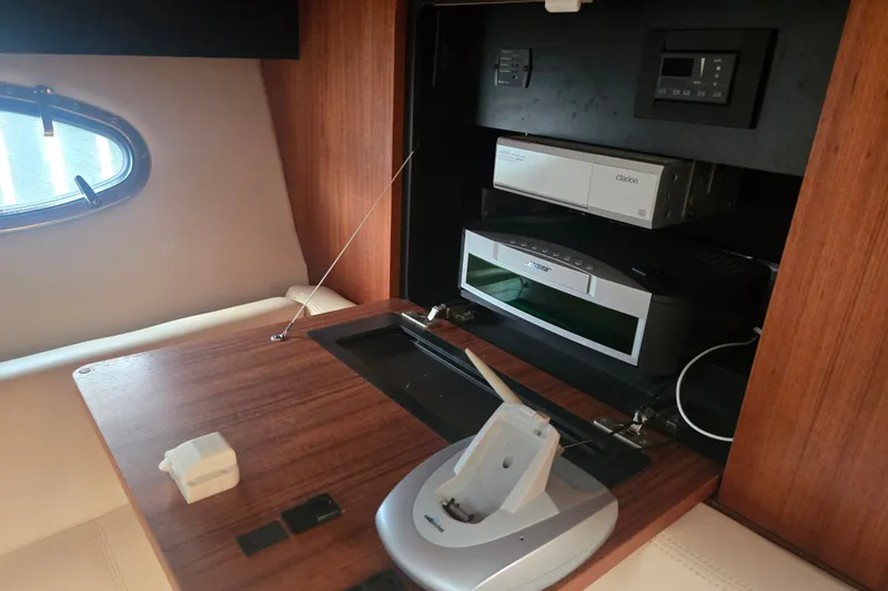 Slide: The Image of Interior of 2005 Tiara Yachts 3600 Open with audio equipment and wooden cabinetry. - 32