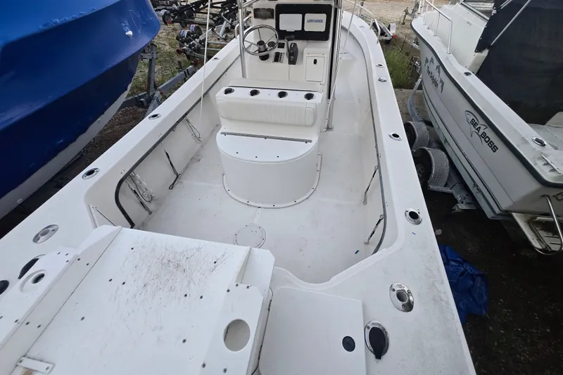Slide: The Image of 2015 May-Craft 2300 CCX boat interior, featuring spacious deck and steering console. - 16