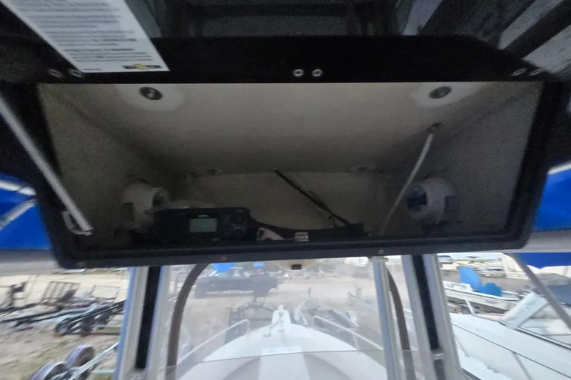 Slide: The Image of 2015 May-Craft 2300 CCX boat console with electronics and storage compartment. - 15