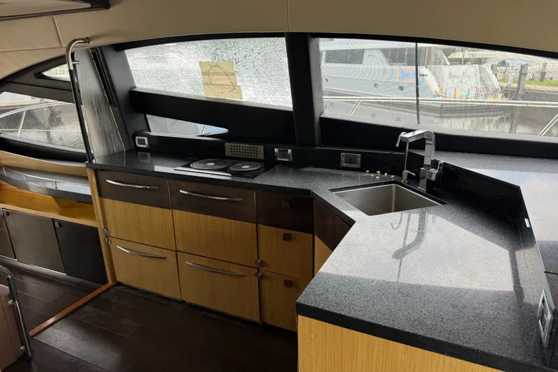 Slide: The Image of Luxurious 2016 Sea Ray L590 yacht kitchen with sleek countertops and modern appliances. - 16