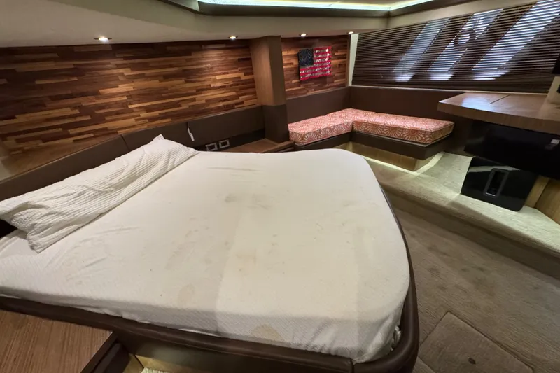 Slide: The Image of Luxurious 2016 Sea Ray L590 yacht cabin with cozy bed and stylish wood accents. - 23