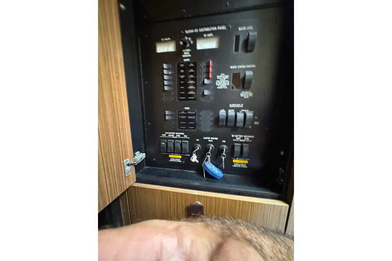Slide: The Image of Electrical control panel inside 2016 Sea Ray L590 yacht, featuring switches and indicators. - 31
