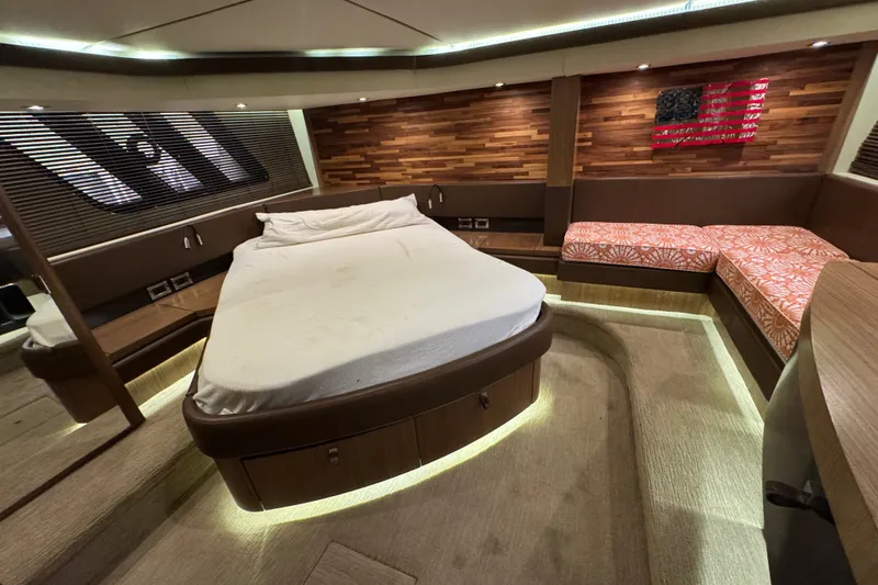 Slide: The Image of Luxurious 2016 Sea Ray L590 yacht bedroom with modern wood accents and ambient lighting. - 22