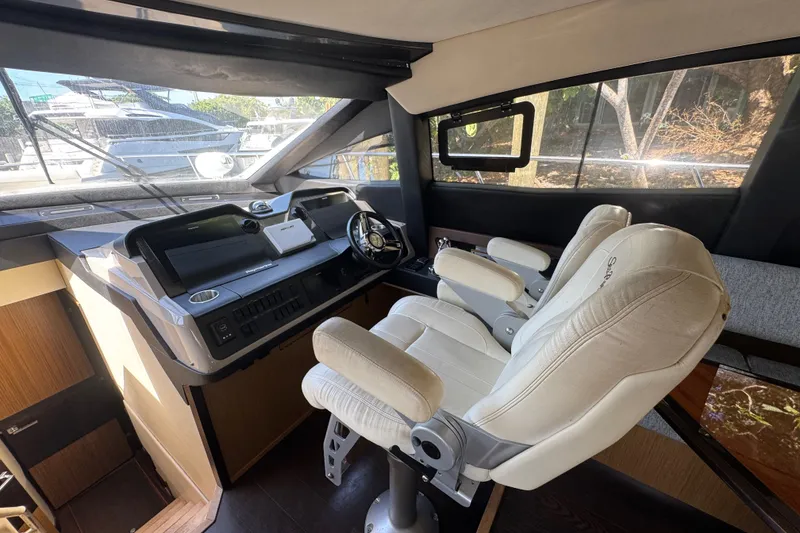 Slide: The Image of Interior helm of 2016 Sea Ray L590 yacht with modern controls and plush seating. - 18