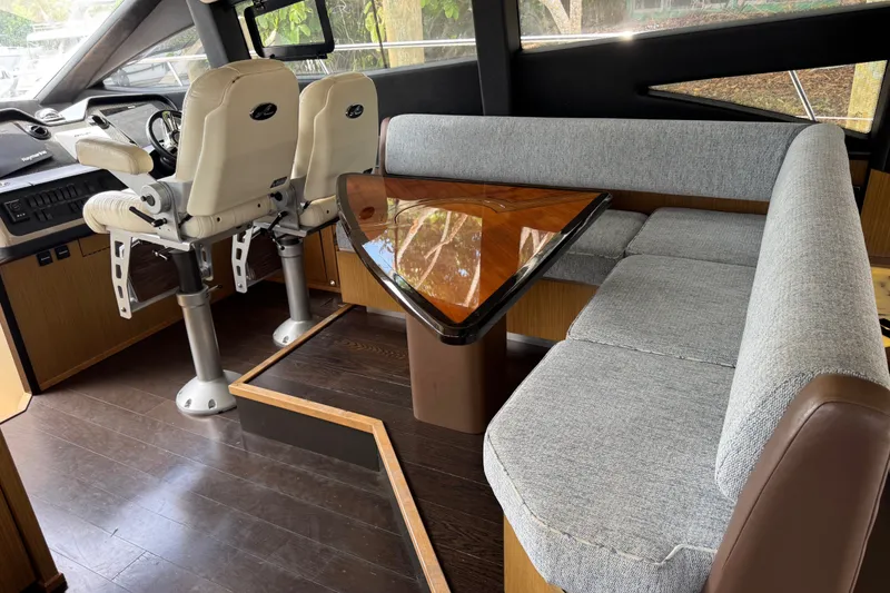 Slide: The Image of Interior of 2016 Sea Ray L590 yacht with helm chairs and elegant dining area. - 17