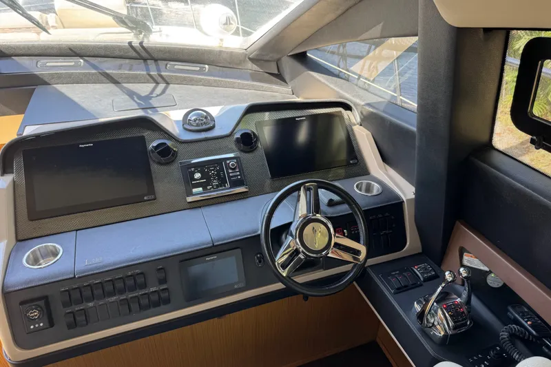Slide: The Image of Helm of 2016 Sea Ray L590 yacht with modern navigation controls and steering wheel. - 19