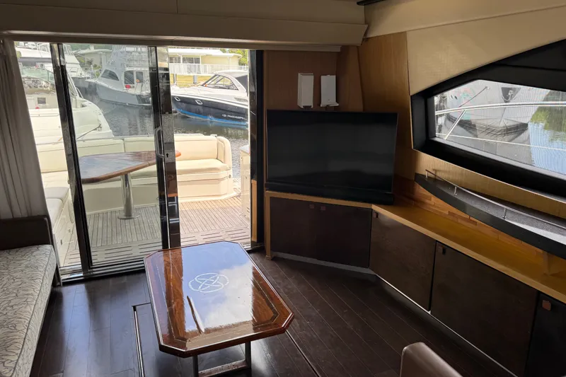 Slide: The Image of Luxurious interior of a 2016 Sea Ray L590 yacht with modern furnishings and marina view. - 15