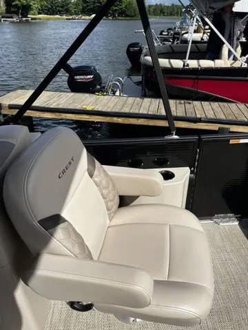 Slide: The Image of A luxurious seat on a pontoon boat overlooking a calm lake and a dock. - 12