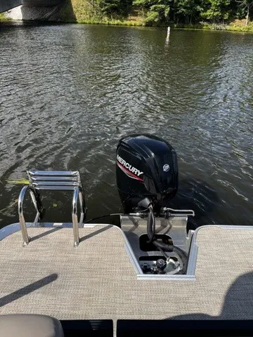 Slide: The Image of A Mercury outboard motor on a pontoon boat in calm waters. - 17