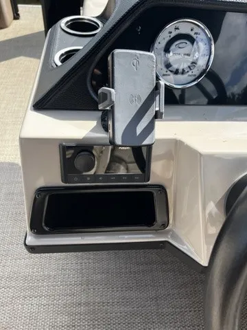 Slide: The Image of Close-up of a 2025 Crest Classic 200 SLC Pontoon dashboard with a phone holder. - 10