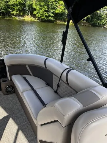Slide: The Image of A sleek pontoon boat with comfortable, cushioned seating and a tranquil lake in the background. - 14