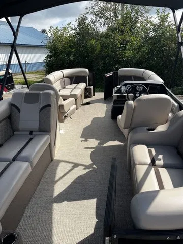 Slide: The Image of The image shows the interior of a Crest Classic 200 SLC Pontoon boat with beige seating. - 20