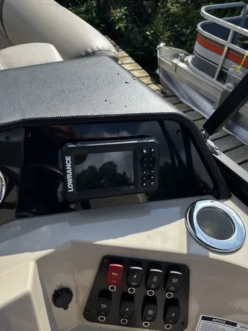 Slide: The Image of The image shows the dashboard of a Crest Classic 200 SLC Pontoon boat with a Lowrance device. - 9
