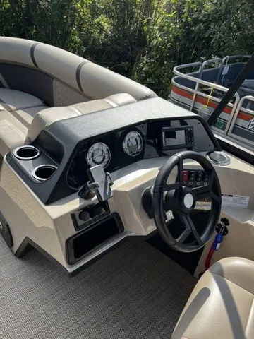 Slide: The Image of The image shows the cockpit of a Crest Classic 200 SLC Pontoon boat with steering wheel and instruments. - 11