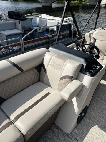 Slide: The Image of The 2025 Crest Classic 200 SLC Pontoon features luxurious seating and a sleek dashboard. - 5