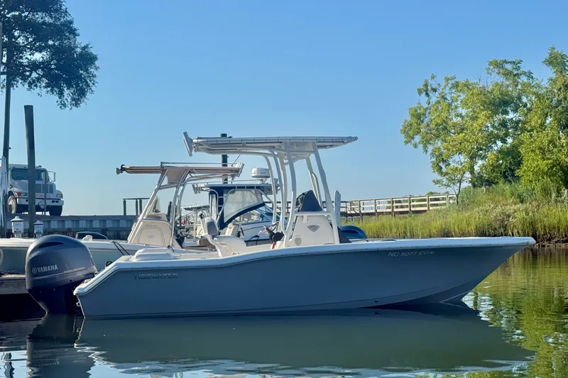 The Image of 2018 Tidewater 210 LXF boat docked on calm water with Yamaha engine. - 0
