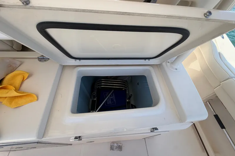 Slide: The Image of Open storage compartment on 2021 Grady-White Canyon 326 boat deck. - 91