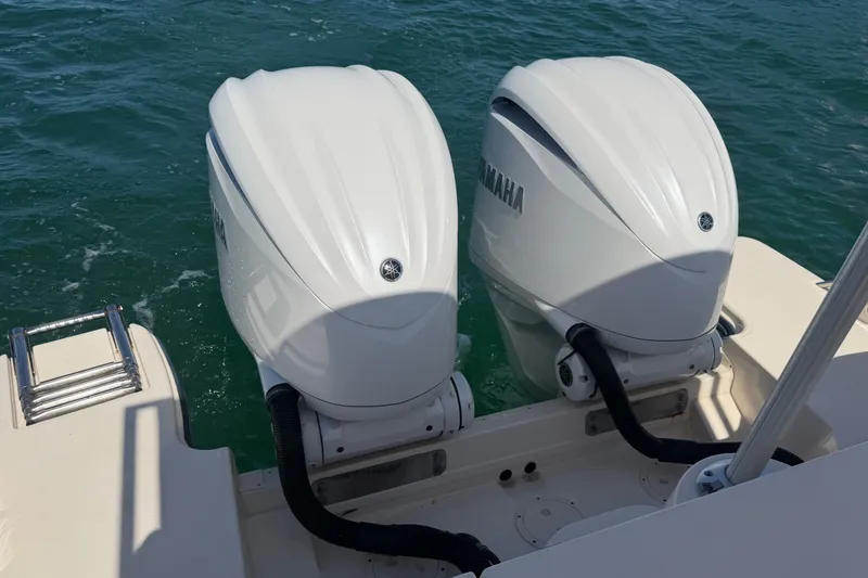Slide: The Image of Twin Yamaha outboard engines on a 2021 Grady-White Canyon 326 boat in water. - 95