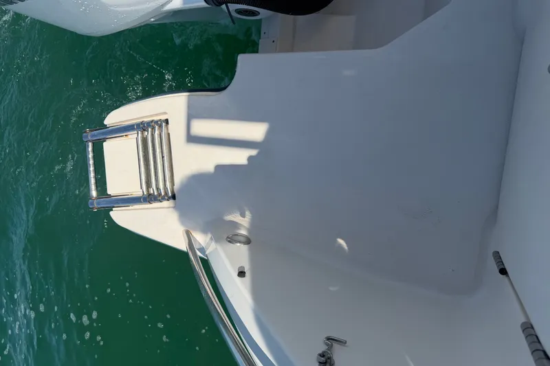 Slide: The Image of 2021 Grady-White Canyon 326 boat ladder and deck over water. - 94