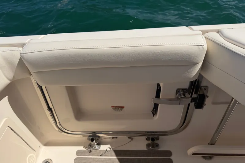 Slide: The Image of 2021 Grady-White Canyon 326 boat interior with white cushioned seating and stainless steel fittings. - 96