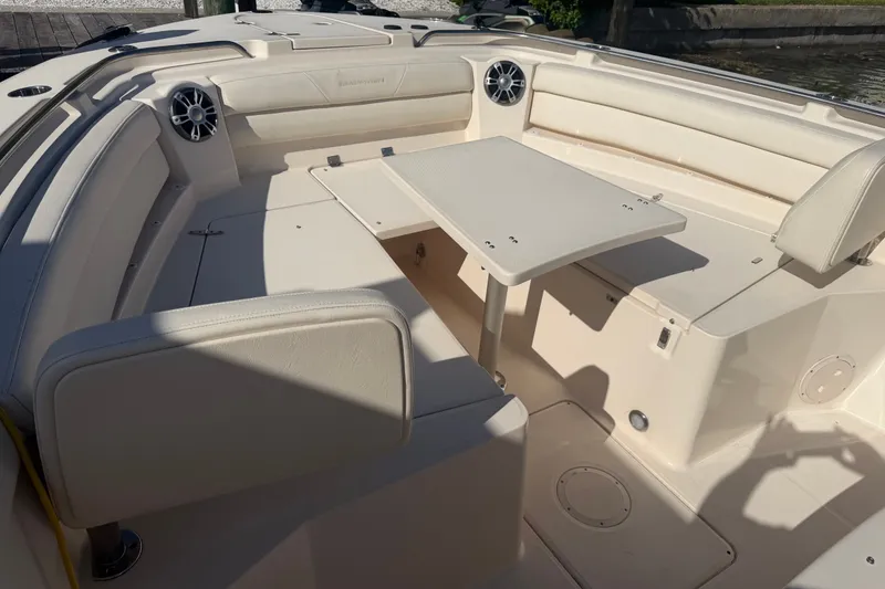 Slide: The Image of 2021 Grady-White Canyon 326 boat interior with seating and table setup. - 58
