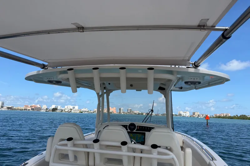 Slide: The Image of 2021 Grady-White Canyon 326 boat on water, city skyline in background. - 113