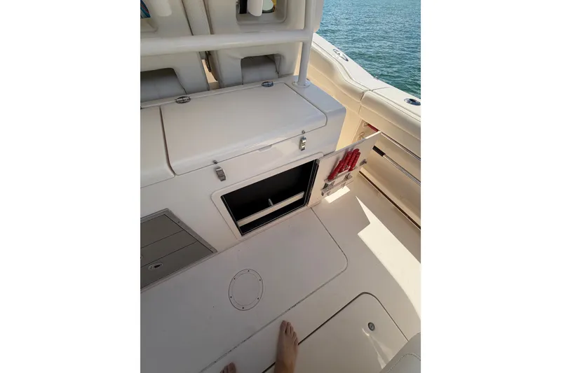 Slide: The Image of 2021 Grady-White Canyon 326 boat interior with open storage compartment. - 87