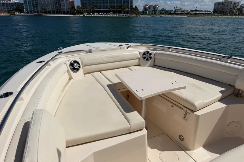 Slide: The Image of 2021 Grady-White Canyon 326 boat interior with seating and table on calm water. - 49