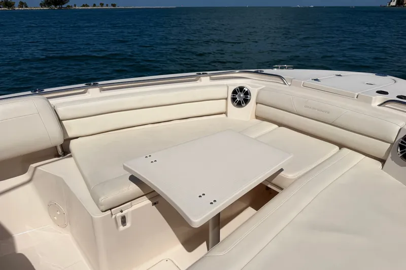 Slide: The Image of 2021 Grady-White Canyon 326 boat interior with seating and table on open water. - 51