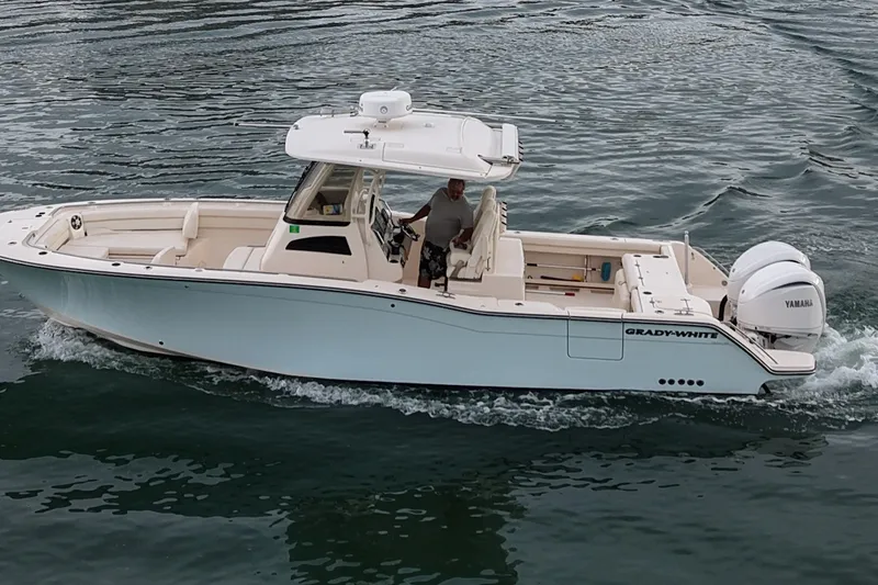 The Image of 2021 Grady-White Canyon 326 boat cruising on water with twin Yamaha engines. - 0