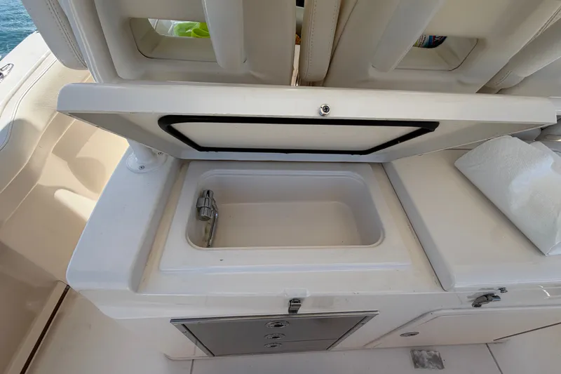 Slide: The Image of 2021 Grady-White Canyon 326 boat sink and storage area detail. - 89