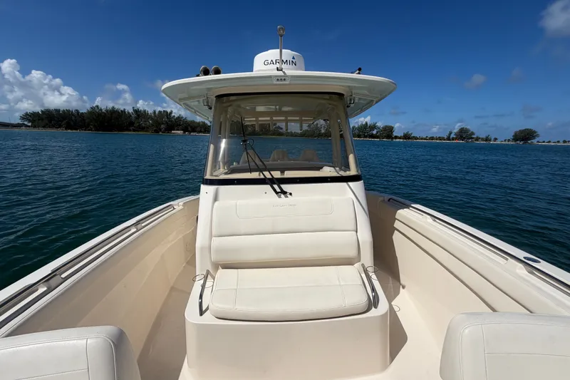 Slide: The Image of 2021 Grady-White Canyon 326 boat on calm water under clear blue sky. - 41