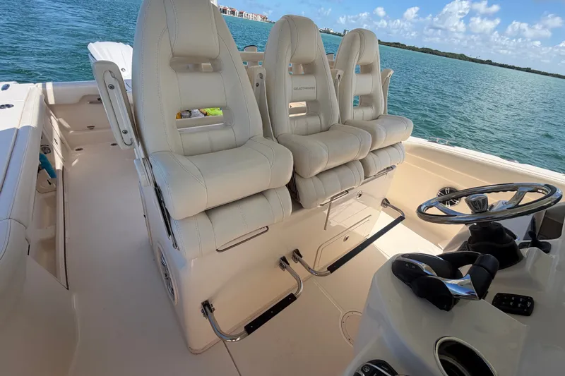 Slide: The Image of 2021 Grady-White Canyon 326 boat interior with luxurious seating and steering wheel. - 84