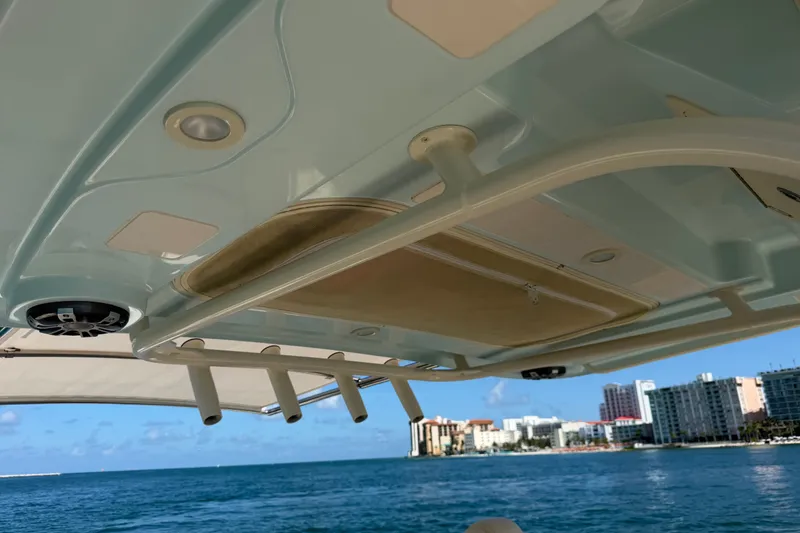 Slide: The Image of 2021 Grady-White Canyon 326 boat interior with rod holders and city skyline view. - 74