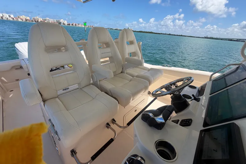 Slide: The Image of Interior of 2021 Grady-White Canyon 326 boat with luxurious seating and control panel. - 83