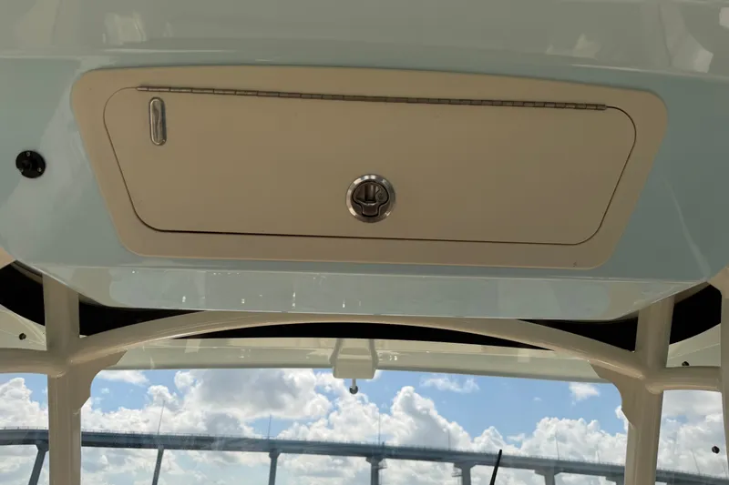 Slide: The Image of 2021 Grady-White Canyon 326 boat storage compartment under clear blue sky. - 72